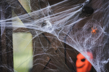close up view of spider net with toy spiders on wooden fence decorated for halloween - Powered by Adobe