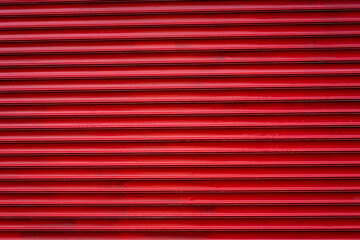 Red painted garage door closeup detail, useable as background. 