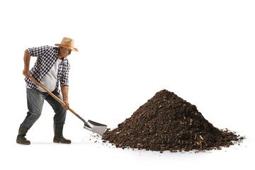 Full length profile shot of a mature farmer digging a pile of earth with a shovel © Ljupco Smokovski