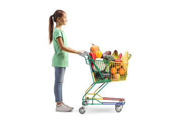 Full length profile shot of a girl waiting with a full shopping cart