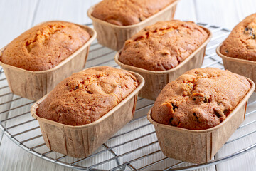 Fototapeta premium Freshly baked mini loaves of cupcakes with raisins.