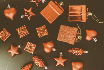 Cozy Christmas decorations: red toys on  black background. Holiday and celebration. Flat lay, top view. 