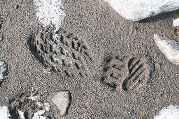 footprint in the sand in snowy mountain