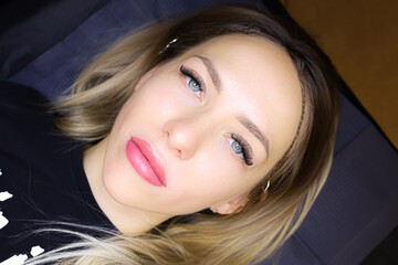beautiful girl model after the procedure of permanent lip makeup