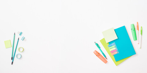 Flat lay frame with school and office supplies on a white background