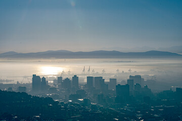 General view of cityscape with multiple modern buildings and skyscrapers in the foggy morning