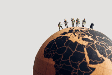 Group of soldiers on top of the earth globe. Military concept