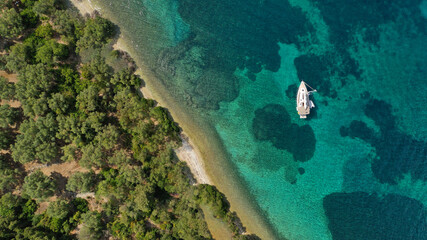 Aerial drone photo of exotic turquoise sandy beach forming a blue lagoon in tropical destination island bay