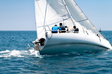 Sailing crew on sailboat during regatta