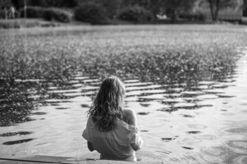 Fototapeta premium Caucasian woman in white shirt in water. Monochrome