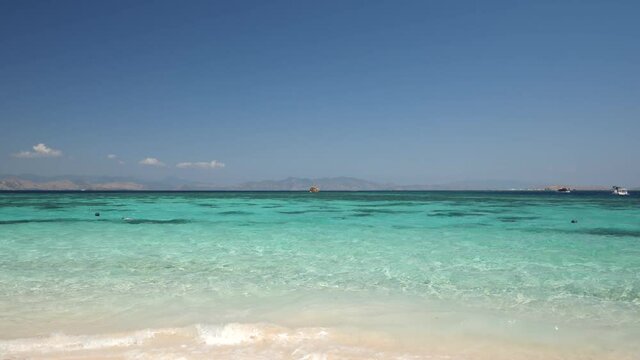 Kanawa Island in Indonesia on the way to Komodo Island. Beautiful turquoise beach with white sand.