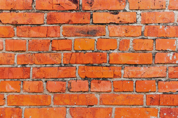 Obraz premium Textured background with old, dirty and red bricks. The wall is made of red ceramic bricks.