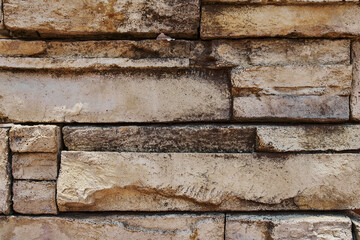 Inlaid cut stone wall inlaid and arranged forming a decorative residential pattern