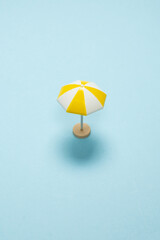 Yellow umbrella on a blue background.