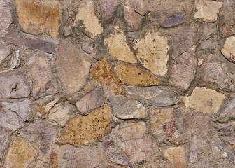 Tidy inlaid stone wall forming a decorative residential pattern