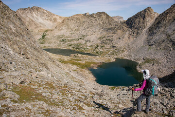 Fototapeta premium Trekking into the breathtaking Cirque of Towers, seen from Shadow Lake, Wind River Range, Wyoming, USA