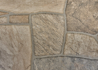 Tidy inlaid stone wall forming a decorative residential pattern