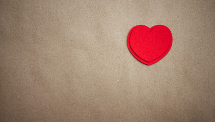 Obraz premium Red heart made of textile fabric on a clean paper background.Texture for a greeting card with a declaration of love.