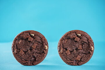 Chocolate cookies with dark and white chocoltae slices on a blue background
