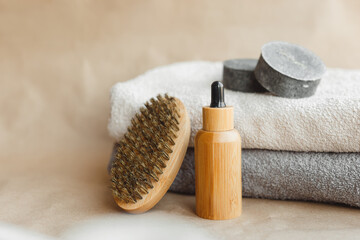 Men spa set with towels, natural solid shampoo, soap, beard brush and aroma oil on paper background