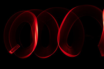 Red circle moving light trails on black background.