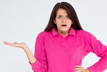 Angry indignant pretty female frowns face in dissatisfaction being abused by someone, feels irritation and expresses bad emotions. Puzzled woman isolated over white background