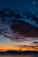 New Bay Bridge expanse with San Francisco during colorful sunset sky