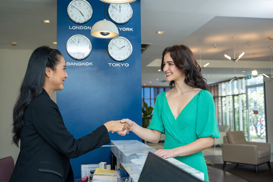 Check In Hotel,Young Woman Checking In At Counter With Reception