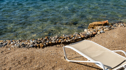 empty sunbed on the sea shore, top view