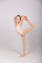 gymnast girl in a rack on one leg on a white background