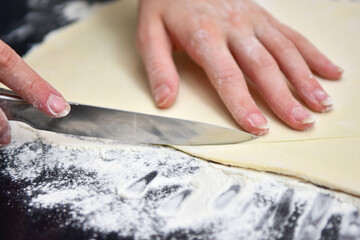 Cutting the dough into croissants. Cooking at home in quarantine