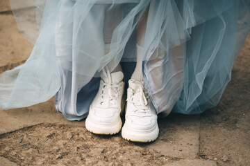 white sneakers and blue ball gown