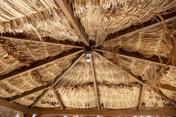 white lamp hanging on wicker ceiling