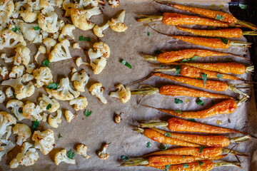 close-up of roasted carrots and cauliflower on parchment paper