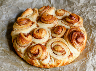 Fresh-baked cinnamon rolls on parchment paper