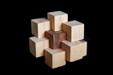 Hand made wooden puzzles on a black background, art of wood