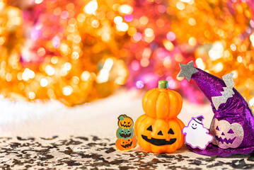 Creative photography depicting an halloween jack o lantern pumpkin head and a purple witches hat...