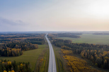 Aerial view of freeway road in autumn forest.