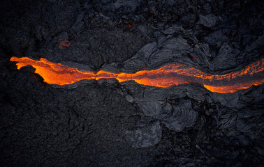 Volcanic lava flowing on rough hot ground