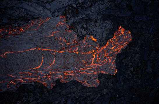 Volcanic lava flowing on rough slope
