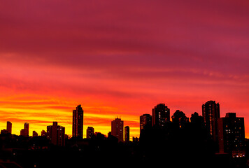 Fototapeta na wymiar City Skyline With Beautiful Vivid Colorful Skies At Sunset Sunrise Silhouette