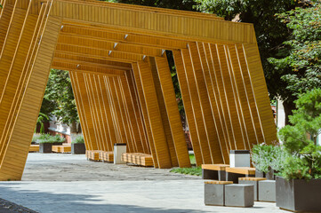 Recreation area on summer pedestrian street, wooden decorations