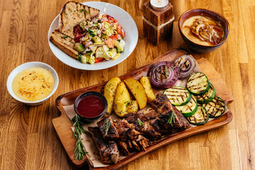 Barbecue chicken with vegetables on wooden table