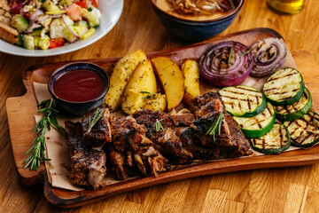 Barbecue chicken with vegetables on wooden table