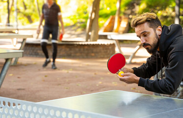 Professional table tennis player focuses on first hitting.