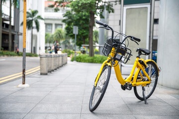 Fototapeta na wymiar Yellow bike in public park building background and view landscap