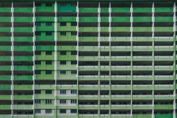 Front view of a an old apartment complex exterior facade on shades of green in Singapore