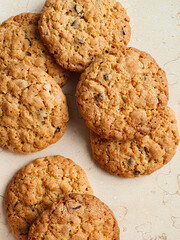 Banch of oatmeal chocolate crispy cookies on a marble table flat lay