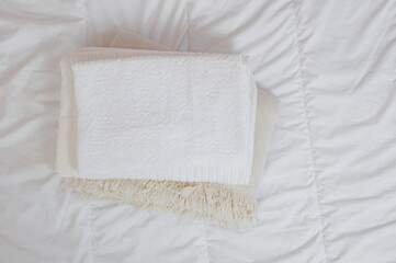 Obraz premium home textiles Flatlay. A stack of towels lies on a white bed