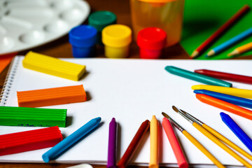 Sheets of paper, glue and scissors on a wooden table. Children's art project, a craft for children. Craft for kids.